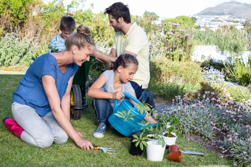Volunteers turning compost in the middle of a garden waste area